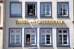 Women looking out the window of the Cathedral Hotel at Strasbourg, France Women looking out the window of the Cathedral Hotel at Strasbourg, France
