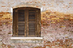 Wooden shutters and brick wall, Burano, Veneto, Italy Wooden shutters and brick wall, Burano, Veneto, Italy