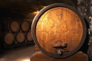 Wooden storage vat with aging wine of Guigal in Ampuis. The end of the vat is carved Wooden storage vat with aging wine of Guigal in Ampuis. The end of the vat is carved