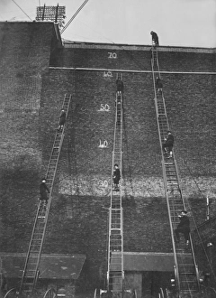 Firefighters climbing wheeled escape ladders Firefighters climbing wheeled escape ladders
