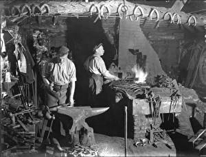 Fittleworth Smithy interior with two blacksmiths Fittleworth Smithy interior with two blacksmiths