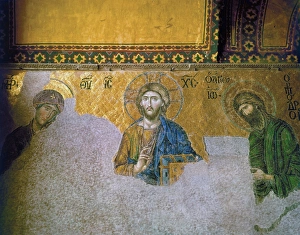 The 13th century Deesis mosaic in the South Gallery of the Hagia Sophia in Istanbul, Turkey, depicting Jesus Christ, the Virgin Mary and John the Baptist. Photograph, 20th century