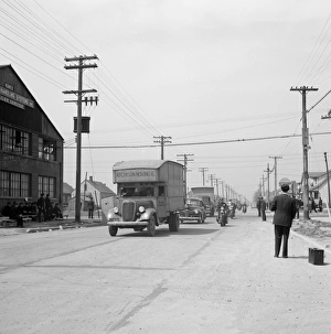 DETROIT, 1942. Moving vans, with a police escort, moving black families' belongings DETROIT, 1942. Moving vans, with a police escort, moving black families' belongings