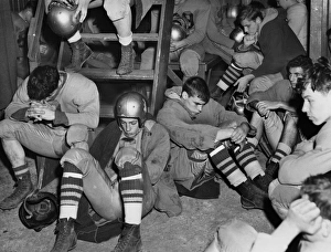 FOOTBALL, 1950. A dejected high school football team in their locker room in Freeport, New York FOOTBALL, 1950. A dejected high school football team in their locker room in Freeport, New York