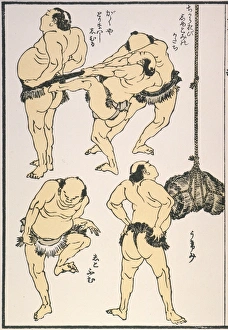 Japanese Sumo wrestlers preparing for a match. Tying the sash Japanese Sumo wrestlers preparing for a match. Tying the sash