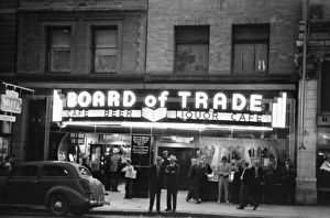 Men standing in front of the Board of Trade bar and gambling house in Butte, Montana Men standing in front of the Board of Trade bar and gambling house in Butte, Montana