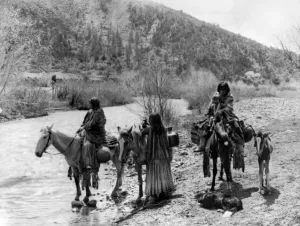 Native American Images Prints: APACHE GROUP, c1906. Group of Apache men and women, one with a child, with horses