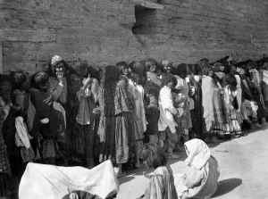 Prints of APACHE RESERVATION, c1899. Line of Apache men, women and children wait for rations outside the agency building at San Carlos, Arizona. Photograph by Katherine Dodge, c1899 Katherine Dodge Prints: Apache Reservation Print, San Carlos Agency Rations Line