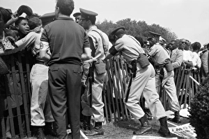 Police attempt to keep Civil Rights demonstrators behind a storm fence at the March Police attempt to keep Civil Rights demonstrators behind a storm fence at the March