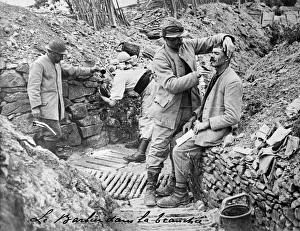 TRENCH BARBER. A French barber shaving a soldier in a trench. Photograph not dated TRENCH BARBER. A French barber shaving a soldier in a trench. Photograph not dated