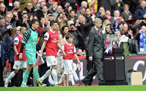 Arsene Wenger the Arsenal Manager and Robin van Persie (Arsenal) lead out the team Arsene Wenger the Arsenal Manager and Robin van Persie (Arsenal) lead out the team