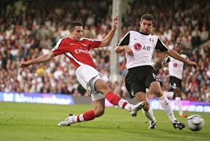 Robin van Persie shoots past Fulham goalkeeper Mark Robin van Persie shoots past Fulham goalkeeper Mark