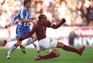 Thierry Henry shoots past Wigan goalkeeper John Filan to score the 2nd Arsenal goal Thierry Henry shoots past Wigan goalkeeper John Filan to score the 2nd Arsenal goal