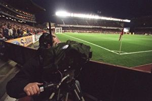 A TV Cameraman works under the floodlights which are on for the last time A TV Cameraman works under the floodlights which are on for the last time