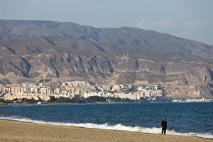 A lone figure on the beach at Roquetas de Mar in Spain A lone figure on the beach at Roquetas de Mar in Spain