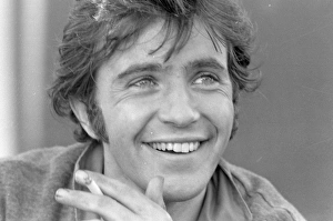David Essex smiling and with cigarette in his hand David Essex smiling and with cigarette in his hand