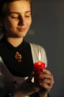 Christian girl holding a Christmas candle Christian girl holding a Christmas candle