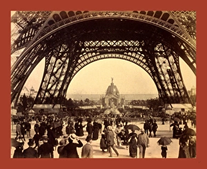 Crowd Of People Walking Under The Base Of Eiffel Tower Crowd Of People Walking Under The Base Of Eiffel Tower