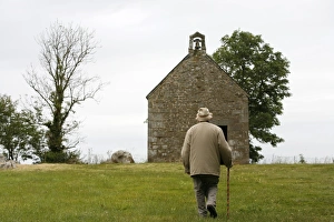 Man walking up to Mont-Dol chapel Man walking up to Mont-Dol chapel
