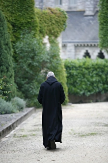 Monk walking in Saint-Pierre of Solesmes abbey Monk walking in Saint-Pierre of Solesmes abbey