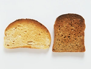 Two pieces of toast, one white, one brown Two pieces of toast, one white, one brown