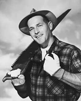 Portrait of lumberjack carrying saw Portrait of lumberjack carrying saw