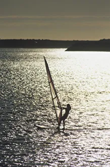 Portugal, Viana do Castelo, man windsurfing at sunset, high angle view Portugal, Viana do Castelo, man windsurfing at sunset, high angle view