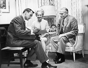 Salesman showing paperwork to mature couple Salesman showing paperwork to mature couple