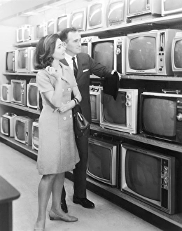 Vintage couple shopping for a television Vintage couple shopping for a television