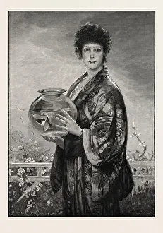 A Woman Holding A Fishbowl Containing Gold Fish A Woman Holding A Fishbowl Containing Gold Fish