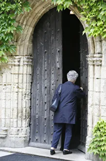 Woman walking into Saint-Pierre of Solesmes abbey church Woman walking into Saint-Pierre of Solesmes abbey church