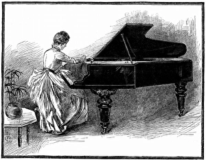 Young woman tuning a grand piano Young woman tuning a grand piano