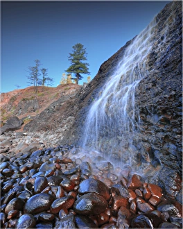 A low angled view of the lower Cockpit falls, which cascade over a steep cliff onto rocks A low angled view of the lower Cockpit falls, which cascade over a steep cliff onto rocks