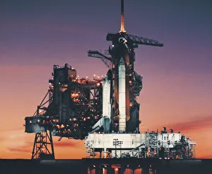 Space Shuttle Columbia on launch pad and the setting sun Space Shuttle Columbia on launch pad and the setting sun