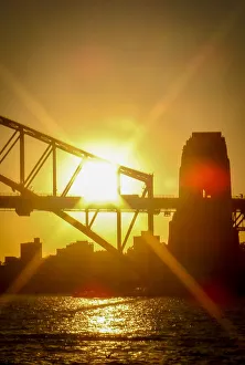 Sunburst through the Sydney Harbour Bridge at sunset Sunburst through the Sydney Harbour Bridge at sunset