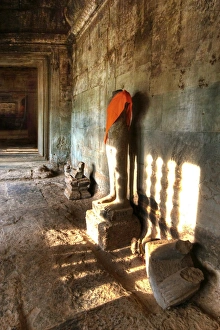 Sunlight Shining Onto The Headless Statue in Angkor Wat, Siem Reap, Cambodia Sunlight Shining Onto The Headless Statue in Angkor Wat, Siem Reap, Cambodia