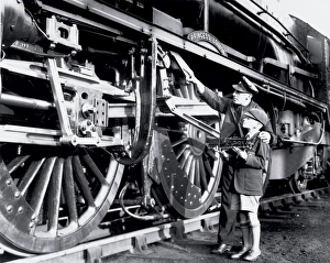 An engine driver explaining the valve gear to a schoolboy An engine driver explaining the valve gear to a schoolboy