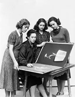 3 young women observe a fourth draw artwork in portfolio 3 young women observe a fourth draw artwork in portfolio
