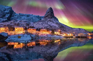 Aurora borealis above snowy islands of Lofoten