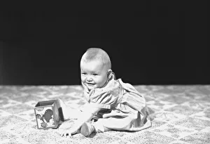 Baby girl (12-15 months) playing on blanket, (B&W) Baby girl (12-15 months) playing on blanket, (B&W)