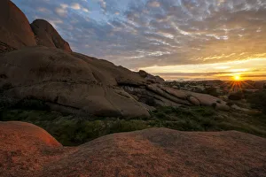 Beautiful Sunrise over the red granite rocks of Spitzkoppe in the Erongo Region of Namibia Beautiful Sunrise over the red granite rocks of Spitzkoppe in the Erongo Region of Namibia
