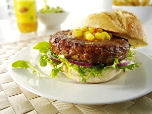 Beef burgers, hamburgers, in rolls with lettuce and garnish Beef burgers, hamburgers, in rolls with lettuce and garnish