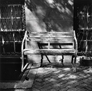 Bench with peeling paint against building wall Bench with peeling paint against building wall