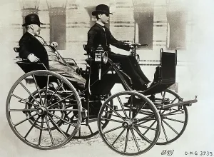 Prints of Gottlieb Daimler enjoys a ride in his horseless carriage in 1885, while his his son, Wilhelm, drives proudly through the streets of Berlin Industrialist Prints: Gottlieb Daimler Riding in First Automobile Print 1885