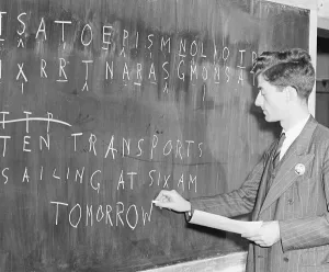Young Adult Man In Uniform Prints: Man At Blackboard Deciphering Code