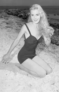 Retro Swimwear Fashion Prints: Model Holding Coconut on Beach