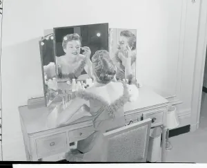 Classic Female Portraits Prints: Model Making up Her Face at Vanity Table