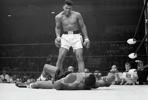 Prints of Heavyweight champion Muhammad Ali stands over Sonny Liston and taunts him to get up during their title fight France Prints: Muhammad Ali's Historic Title Fight Print