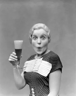 Blonde Woman In Black Dress With Stripes & White Buttons & Trim Holding A Pilsner Glass Blonde Woman In Black Dress With Stripes & White Buttons & Trim Holding A Pilsner Glass