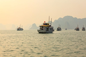 boats cruising around karst in the world famous place halong bay in north Vietnam boats cruising around karst in the world famous place halong bay in north Vietnam